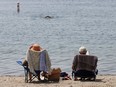 A couple sit and read on the Toronto waterfront, Thursday July 6, 2023.