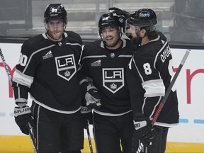Los Angeles Kings left winger Kevin Fiala (22) celebrates with Pierre-Luc Dubois (80) and defenceman Drew Doughty (8) after scoring.