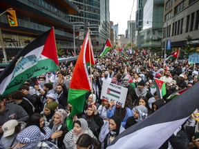 Pro-Palestinian march makes its way north along Bay St. in downtown Toronto on Monday, October 9, 2023.