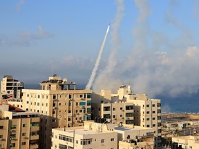 Dozens of rockets were fired from the blockaded Gaza Strip towards Israel on Oct. 7, 2023, an AFP journalist in the Palestinian territory said, as sirens warning of incoming fire blared in Israel.