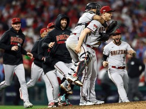 Paul Sewald of the Arizona Diamondbacks celebrates with teammates after beating the Philadelphia Phillies at Citizens Bank Park on October 24, 2023 in Philadelphia.