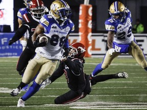 Bombers receiver Rasheed Bailey eludes tacklers to score a 68-yard touchdown in the Blue Bombers 36-13 win over the Calgary Stampeders Friday night.
