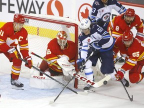 Flames goaltender Jacob Markstrom made 34 saves to beat Mark Scheifele and the Winnipeg Jets in the NHL season opener for both teams Wednesday.