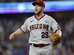 Merrill Kelly of the Arizona Diamondbacks walks across the field after the fifth inning against the Texas Rangers during Game 2 of the World Series at Globe Life Field on Oct. 28, 2023 in Arlington, Texas.