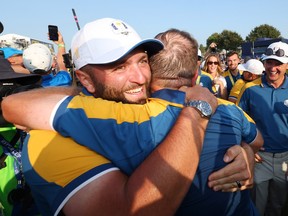 Jon Rahm and Shane Lowry of Team Europe celebrate on the 18th green during the Sunday singles matches of the 2023 Ryder Cup at Marco Simone Golf Club on October 1, 2023 in Rome, Italy.