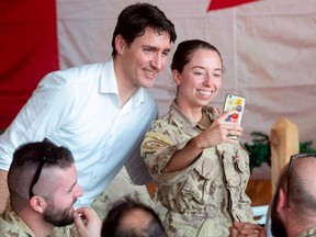 Prime Minister Justin Trudeau takes a selfie with a Canadian service member serving in Mali in 2018.