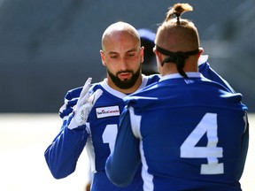 Redha Kramdi, left, with Bombers linebacker Adam Bighill, made a heads up play by not tackling Dominque Rhymes of the B.C. Lions in a crucial Winnipeg win.