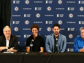 General manager Kevin Cheveldayoff (l to r), centre Mark Scheifele, goalie Connor Hellebuyck and head coach Rick Bowness, were on hand to discuss Scheifele and Hellebuyck signing long-term contracts with the Winnipeg Jets.