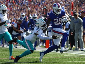 Latavius Murray of the Buffalo Bills runs the ball as Jerome Baker of the Miami Dolphins makes the tackle at Highmark Stadium on October 1, 2023 in Orchard Park, New York.