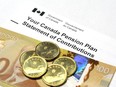 A Canada Pension Plan Statement of Contributions with a 100 dollar banknote and dollar coins.