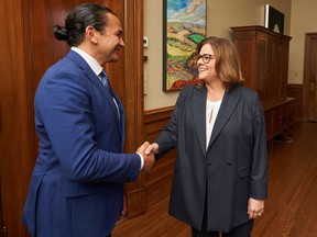 Manitoba premier-designate Wab Kinew, left, meets with outgoing Manitoba Premier Heather Stefanson in the premier's office in Winnipeg, Thursday, Oct. 5, 2023. Elections Manitoba says unofficial results from Tuesday's election show Stefanson narrowly hung on to her legislature seat for the Progressive Conservatives.