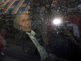 Seen through a police vehicle window, Canadian-Finnish fashion mogul Peter Nygard leaves a courthouse in Toronto on Sept. 26, 2023.