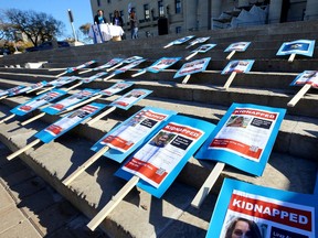Signs are laid out on the steps of the Manitoba Legislative Building