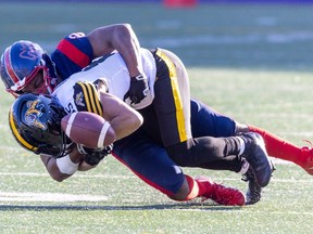 Alouettes' Avery Williams forces Hamilton Tiger-Cats Kiondre Smith to fumble during first half of Canadian Football League East Division semifinal playoff game in Montreal on Saturday, Nov. 4, 2023. The Alouettes recovered the ball.