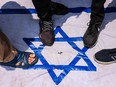 Malaysian Muslim activists and Palestinian nationals step on an flag of Israel to express solidarity with the people of Palestine on October 13, 2023 in Kuala Lumpur, Malaysia.