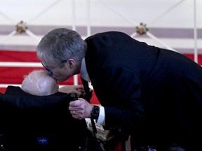 James "Chip" Carter kisses the head of his father, former U.S. president Jimmy Carter, during a tribute service for former first lady Rosalynn Carter at Glenn Memorial Church in Atlanta, Ga., on Tuesday, Nov. 28, 2023. Rosalynn Carter died on Nov. 19, aged 96, just two days after joining her husband in hospice care at their house in Plains, Ga.