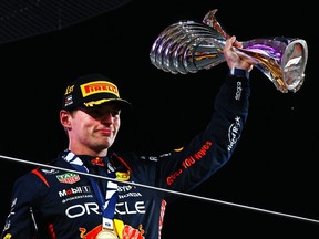 Race winner Max Verstappen of the Netherlands and Oracle Red Bull Racing celebrates on the podium during the F1 Grand Prix of Abu Dhabi at Yas Marina Circuit on November 26, 2023 in Abu Dhabi, United Arab Emirates.