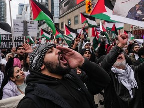 A pro-Palestine march gathers in a Toronto intersection on Sunday, Oct. 29, 2023. Protesters took to the street in support of the people in the Gaza Strip amid an ongoing war between Israel and Hamas.