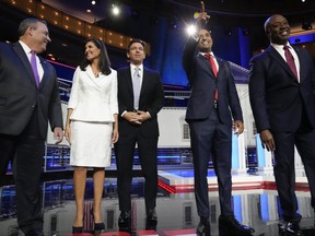 Republican presidential candidates from left, former New Jersey Gov. Chris Christie, former UN Ambassador Nikki Haley, Florida Gov. Ron DeSantis, businessman Vivek Ramaswamy and Sen. Tim Scott, R-S.C., stand on stage before a Republican presidential primary debate hosted by NBC News Wednesday, Nov. 8, 2023, at the Adrienne Arsht Center for the Performing Arts of Miami-Dade County in Miami.