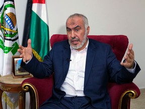 Ghazi Hamad, a member of Hamas' decision-making political bureau, speaks with the media in Beirut on Oct. 26.