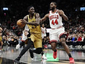 Raptors' Pascal Siakam (left) drives past Bulls' Patrick Williams (right) during second half NBA action in Toronto, Friday, Nov. 24, 2023.