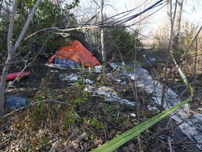 Crime scene tape surrounds a tent near the Red River