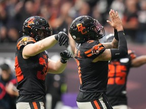 B.C. Lions quarterback Vernon Adams Jr., right, and David Mackie celebrate after Adams Jr. scored a touchdown during the first half of the CFL western semi-final football game against the Calgary Stampeders, in Vancouver, on Saturday, November 4, 2023.