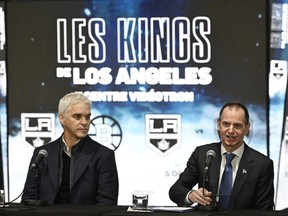 Quebec Finance Minister Eric Girard speaks at a news conference, Tuesday, Nov. 14, 2023 at the Videotron Centre in Quebec City as Luc Robitaille, president of the Los Angeles Kings, left, looks on. Quebec Premier François Legault is defending his government's decision to spend up to $7 million to bring the Kings to Quebec City for two NHL pre-season games next year.