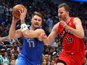 Luka Doncic #77 of the Dallas Mavericks drives past Jakob Poeltl #19 of the Toronto Raptors in the second quarter at American Airlines in Dallas on Wednesday night.
