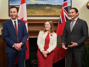 Deputy Prime Minister and Finance Minister Chrystia Freeland, centre, meets with Manitoba Premier Wab Kinew, right and Manitoba's Minister of Finance Adrien Sala at the Manitoba Legislative Building in Winnipeg on Wednesday, Nov. 8, 2023. The Manitoba government has introduced a bill to temporarily lift the provincial tax on fuel.