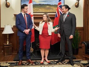 Deputy Prime Minister and Finance Minister Chrystia Freeland, centre, meets with Manitoba Premier, Wab Kinew, right, and Manitoba's Minister of Finance, Adrien Sala at the Manitoba Legislative Building in Winnipeg on Wednesday, Nov. 8, 2023.