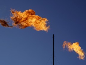 Flares burn off methane and other hydrocarbons at an oil and gas facility in Lenorah, Texas, Friday, Oct. 15, 2021.