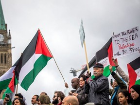 Demonstrators in support of Palestinians wave Palestinian flags during a protest in Toronto, on Oct. 9.
