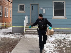 A Winnipeg Police forensics officer at the scene of a multiple homicide