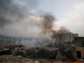 Smoke billows during an Israeli raid at the Jenin refugee camp, in the occupied West Bank on December 5, 2023.