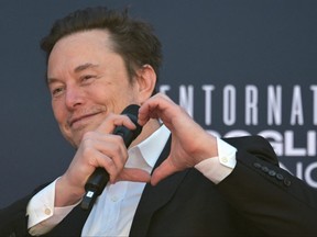X (formerly Twitter) CEO Elon Musk makes a heart with his hands during the Atreju political meeting organised by the young militants of Italian right wing party Brothers of Italy (Fratelli d'Italia) on December 16, 2023 at the Sant'Angelo Castle in Rome.