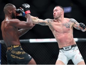 Colby Covington of the United States punches Leon Edwards of Great Britain in a welterweight fight during the UFC Fight Night event at T-Mobile Arena on December 16, 2023 in Las Vegas, Nevada.