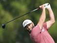 Jon Rahm from Spain plays his second shot on the second hole hole during the final round of the DP World Tour Championship golf tournament, in Dubai, United Arab Emirates, Sunday, Nov. 19, 2023.