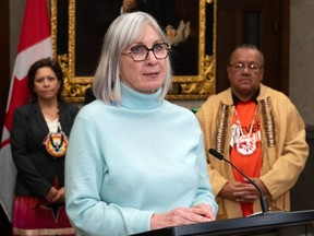 Indigenous Services Minister Patty Hajdu, with Cowessess Chief Erica Beaudin, left, and AFN Ontario Regional Chief Glen Hare, speaks in the foyer of the House of Commons, Monday, December 11, 2023.