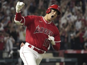 Los Angeles Angels' Shohei Ohtani celebrates as he rounds first after hitting a two-run home run during the seventh inning of a baseball game against the New York Yankees Monday, July 17, 2023.