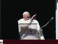 Pope Francis waves during the Angelus noon prayer from the window of his studio overlooking St.Peter's Square, at the Vatican, Sunday, Dec. 17, 2023.