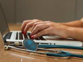 A health care worker using a laptop