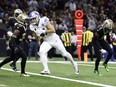 Detroit Lions tight end Sam LaPorta (87), defended by New Orleans Saints cornerback Alontae Taylor (1) and safety Jordan Howden (31) runs for a touchdown Sunday, Dec. 3, 2023, in New Orleans.