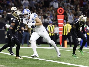 Detroit Lions tight end Sam LaPorta (87), defended by New Orleans Saints cornerback Alontae Taylor (1) and safety Jordan Howden (31) runs for a touchdown Sunday, Dec. 3, 2023, in New Orleans.