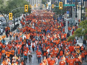 People attend the second annual Orange Shirt Day Survivors Walk and Pow Wow on National Day for Truth and Reconciliation in Winnipeg on Friday, Sept. 30, 2022. A bill to make Orange Shirt day a statutory holiday in Manitoba has passed its final vote in the legislature.