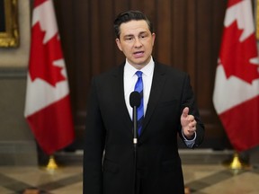 Conservative Leader Pierre Poilievre speaks to reporters in the foyer of the House of Commons on Parliament Hill in Ottawa on Tuesday, Sept. 19, 2023.