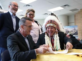 Officials sign a memorandum of understanding at Portage Place