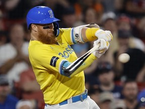 Boston's Justin Turner hits a single during a game against the Baltimore Orioles.