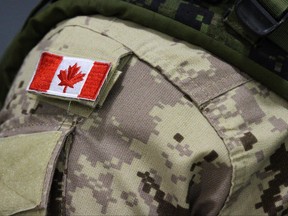 A Canadian flag patch sits is shown on the shoulder of a member of the Canadian Armed Forces in Trenton, Ont., on Thursday, Oct. 16, 2014.