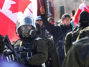 Police begin to break up a protest organized by truck drivers opposing vaccine mandates on Feb. 18, 2022 in Ottawa, Ontario, Canada.